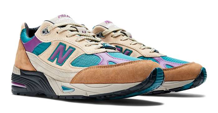 Side view of brown, purple, and teal New Balance shoes.
